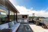 View of rooftop terrace with an outdoor kitchen and a water view