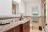 Bathroom featuring vanity, tile walls, tile patterned floors, and toilet