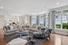 Additional view of the family room featuring 10' ceilings and a comfortable seating area overlooking the water, with an open flow into the kitchen.