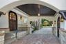 Property entrance with stucco siding and covered porch