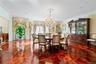Spacious room featuring intricate parquet wood flooring, a crystal chandelier, recessed lighting, crown molding, and wainscoting