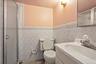 Bathroom with a glass-enclosed shower, a white porcelain toilet, and a vanity with an integrated sink