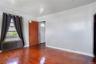 Interior space featuring wood-finish flooring, light gray walls, and white baseboards