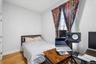 1st Floor Apartment bedroom with light wood flooring and light-colored walls