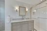 Bathroom with vanity and a shower stall