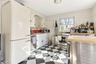 Kitchen with a sink, wood counters, white cabinetry, appliances with stainless steel finishes, and light floors