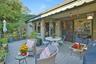 Wooden terrace with outdoor dining space with electric powered awning.