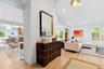 Living room featuring light wood-style flooring, high vaulted ceiling, and recessed lighting
