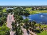 Beautifully landscaped and inviting entrance with golf course and water views
