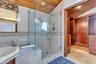 Bathroom with wood ceiling, a garden tub, a sauna / steam room, a shower stall, and light wood finished floors