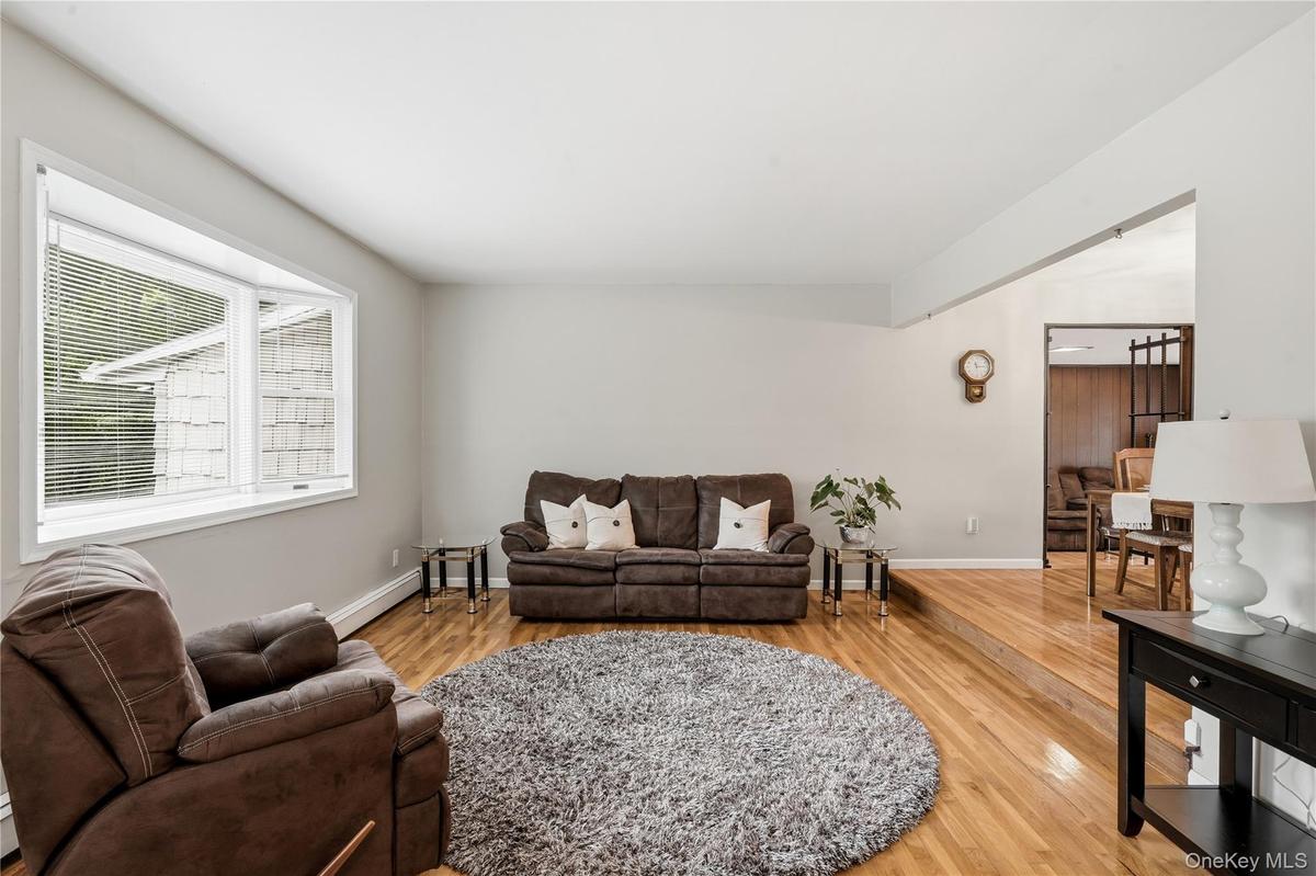 Sunken Living Room with Bay Window and Hardwood Floors