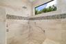 Walk-in shower with waterfall wall