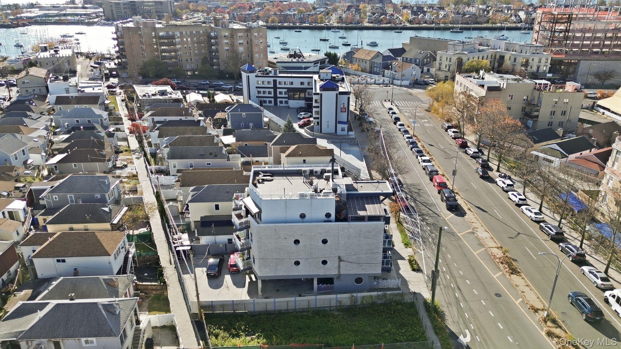 Aerial view of property's location with a nearby body of water and nearby urban area