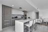 Dining area beneath designer pendants with panoramic city views