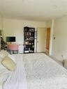 Carpeted bedroom with ornamental molding and baseboards