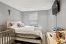 Bedroom featuring recessed lighting, a window with horizontal blinds, and wood-finish flooring