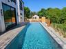 View of swimming pool featuring a fenced in pool, a deck, and a fenced backyard