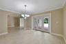 GRACEFUL ARCHED OPENINGS lead to the formal Dining Room, where French doors invite you outside to your PRIVATE BACKYARD RETREAT.