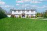 Colonial inspired home with a chimney, a front lawn, and fence
