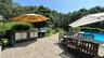 View of patio / terrace featuring a fenced in pool, an outdoor kitchen, outdoor dining space, a sink, and a grill