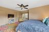 Bedroom featuring a ceiling fan and two closets