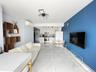 Living area with a baseboard radiator, light marble finish floors, and a wall mounted AC