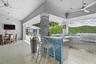 Wall to wall sliding glass doors open to covered terrace