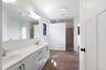 Walk-in shower and dual vanity in primary