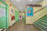 Corridor featuring a paneled ceiling, wood finished floors, a baseboard heating unit, recessed lighting, and stairs
