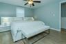 Bedroom with light hardwood / wood-style flooring and ceiling fan