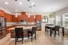 This kitchen has double ovens and a microwave.