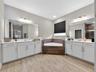 Spa-like Primary Bath with Garden Tub, Two Vanities, and Walk-in Shower