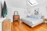 Bedroom featuring vaulted ceiling, a baseboard heating unit, and light wood-type flooring