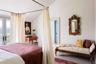 Bedroom with lofted ceiling, french doors, and access to exterior