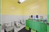 Bathroom featuring tile patterned flooring, a wainscoted wall, and tile walls