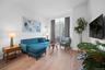 Living area with light wood-style flooring, crown molding, and baseboards