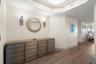The moment you step through the foyer, the home begins to unfold in a way that feels both welcoming and effortlessly refined.