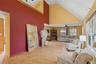 Living room featuring ceiling fan, high vaulted ceiling, and light wood-type flooring