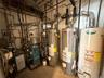 Utilities featuring gas water heater and a heating unit