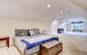Spacious bonus room featuring sloped ceilings, recessed lighting, neutral-toned carpeting, and a double window