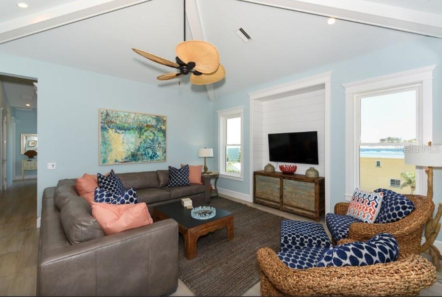 Top floor primary living area with vaulted ceilings and wood beams