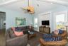 Top floor primary living area with vaulted ceilings and wood beams