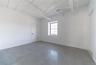 Empty room with baseboards and finished concrete floors