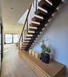 Stairs with wood-type flooring and a water view
