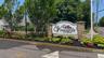 Beautiful Entrance sign featuring stone pillars and a white arched panel