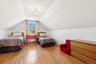 Bedroom with lofted ceiling, a chandelier, light wood-type flooring, and radiator heating unit