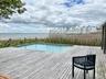 Swimming pool featuring a deck with water view