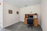 Office featuring dark carpet and baseboards