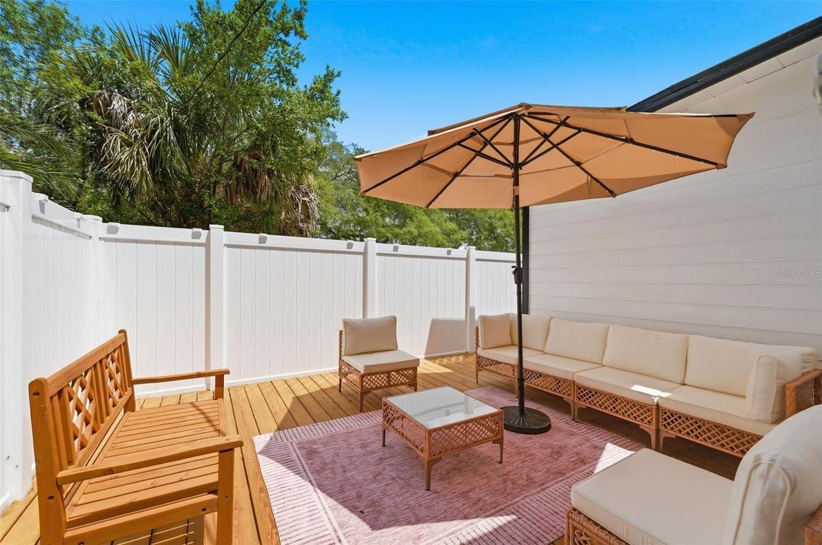 Deck in the backyard, on the left side.