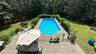 View of pool featuring a fenced in pool, fence, a lawn, and a patio